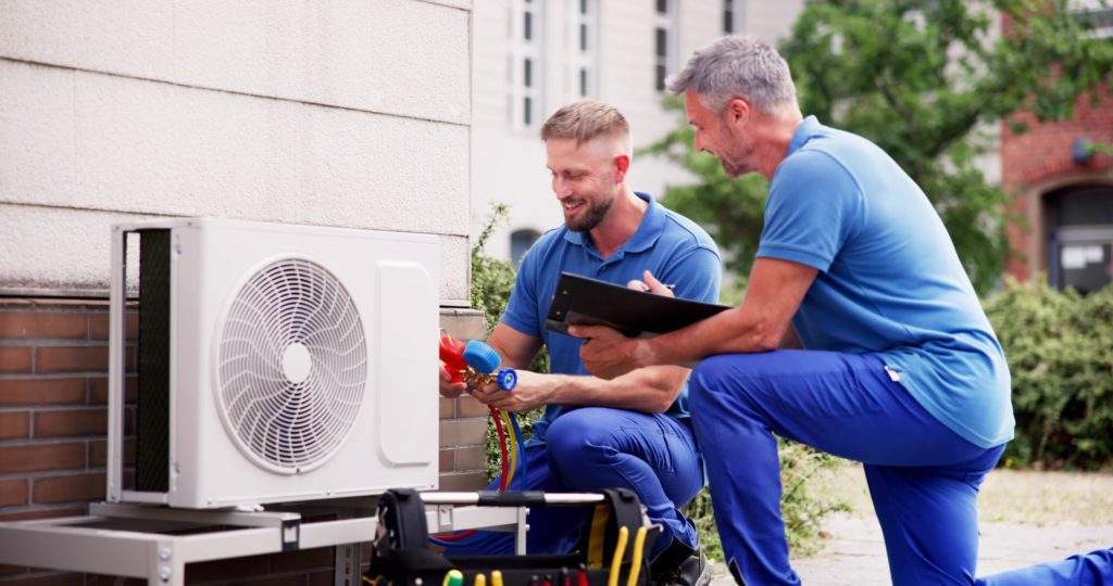 Photo of heat pump HVAC engineers at work